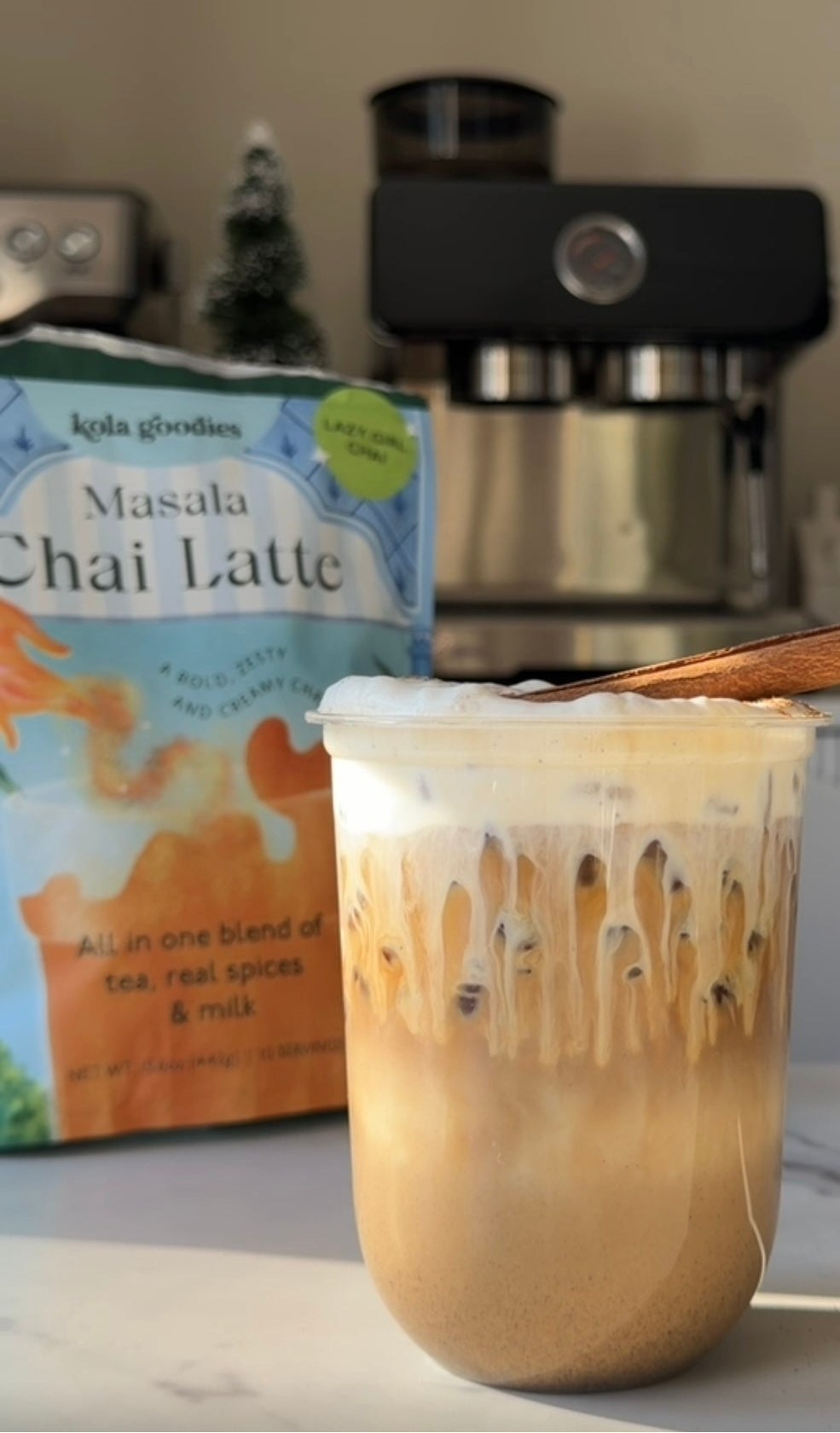 Glass of Masala Chai Latte with a box of the product in the background