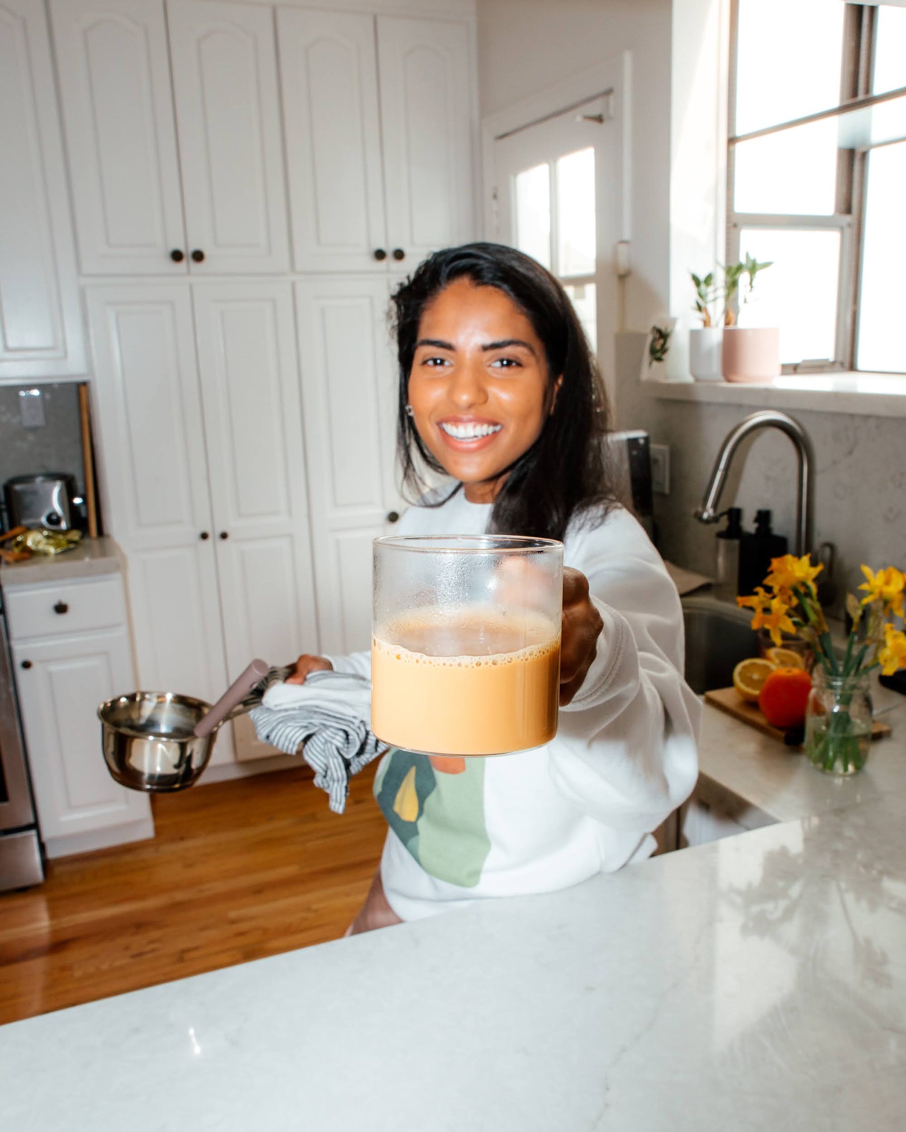 girl holding a cup of tea, known as chai in south asia