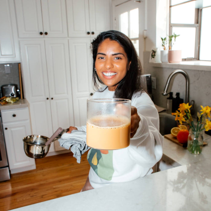 girl holding a cup of tea, known as chai in south asia