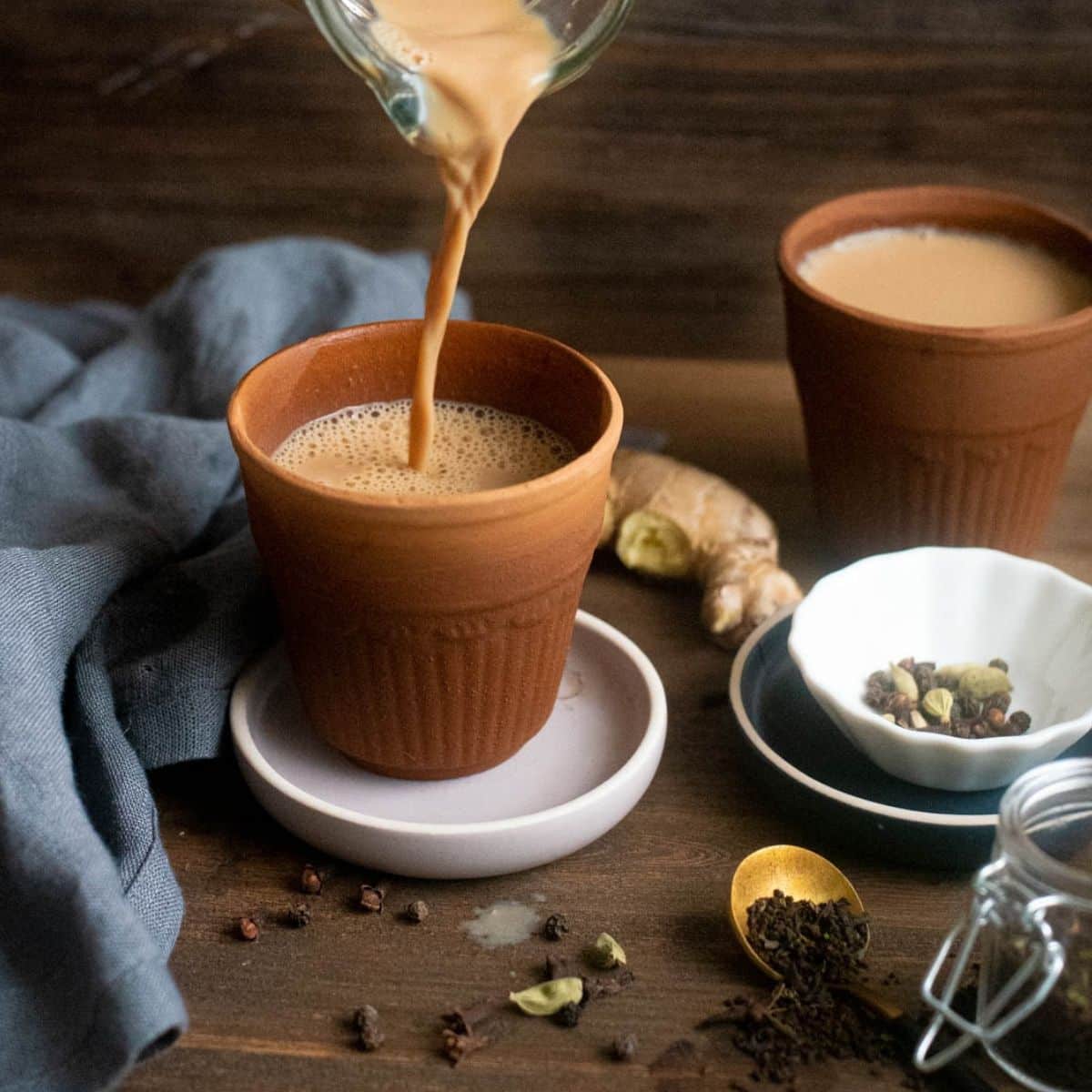 Pouring hot masala chai into a cup